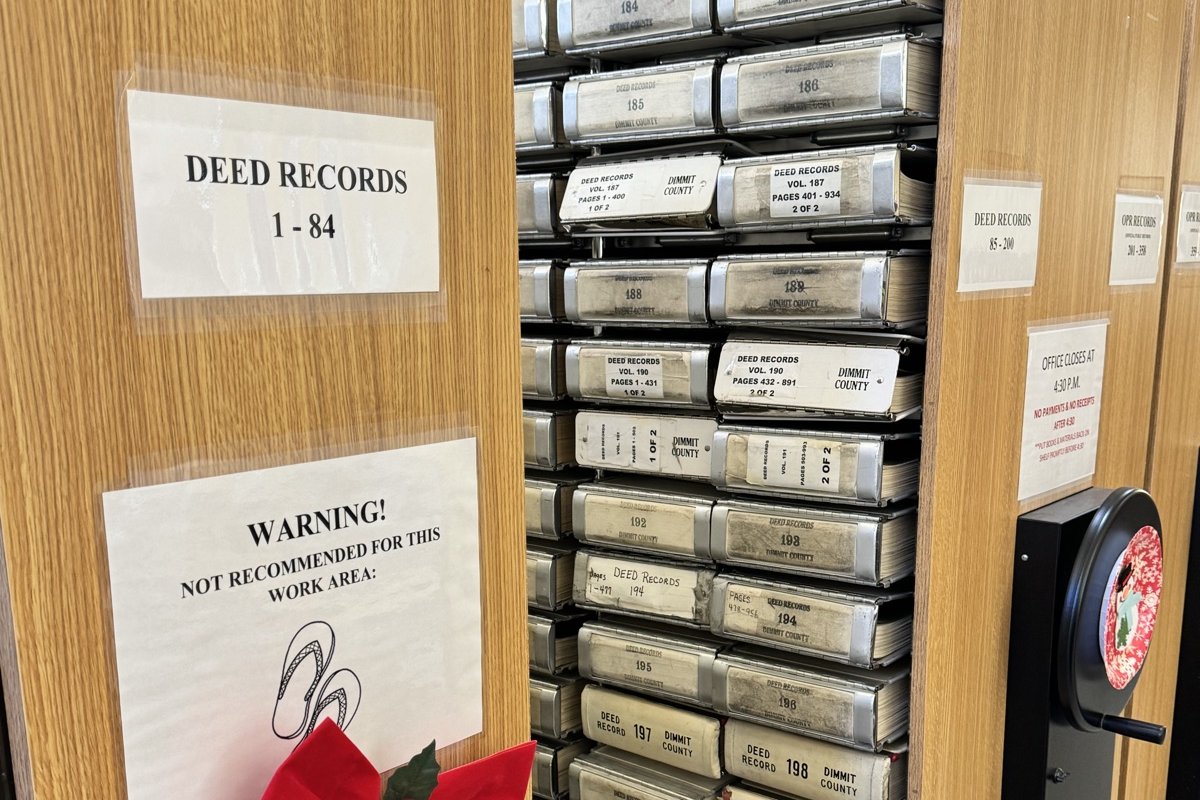 Deed records drawers in a Texas county clerk's office, labeled DEED RECORDS 1-84
